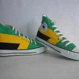 Collectors Items  Jamaican tricolor high tops in green, black and yellow, angled side views.