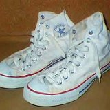 Collectors Items  Vintage white high tops, angled side views.