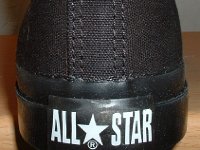 Core Monochrome Black High Top Chucks  Closeup of the rear All Star logo on a made in China black monochrome high top.