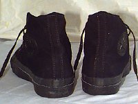 Core Monochrome Black High Top Chucks  Made in USA lack monochrome high tops, rear view. Note that the heel patch is embossed black, like the ankle patch.
