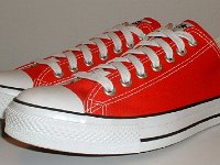 Core Red Low Cut Chucks  Angled side view of red low cut chucks.