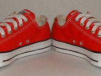 Core Red Low Cut Chucks  Angled front view of red low cut chucks.