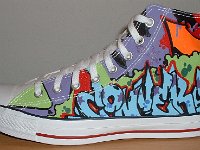 Chucks With Custom Print Pattern Uppers  Outside view of a left white graffiti high top.