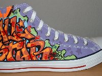 Chucks With Custom Print Pattern Uppers  Outside view of a right white graffiti high top.