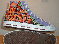 Chucks With Custom Print Pattern Uppers  Outside and sole views of white graffiti high tops.