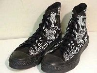 Chucks With Custom Print Pattern Uppers  Skateboard print monochrome black high tops, angled front and side view.