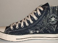 Denim Chuck Taylors  Inside patch view of a right blue denim high top with stitched details.