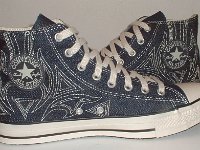 Denim Chuck Taylors  Inside patch views of blue denim high tops with stitched details.