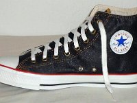 Denim Chuck Taylors  Right navy blue coated denim high top, inside patch view.