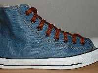 Denim Chuck Taylors  Outside view of a right coated light blue denim high top with brown laces.