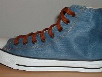 Denim Chuck Taylors  Outside view of a left light blue coated denim high top with brown laces.