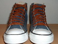 Denim Chuck Taylors  Front view of light blue coated denim high tops with brown shoelaces.