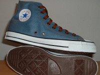 Denim Chuck Taylors  Inside patch and sole views of light blue coated denim high tops with brown shoelaces.