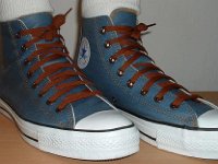 Denim Chuck Taylors  Wearing light blue coated denim high tops with brown shoelaces, angled front view.