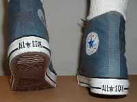 Denim Chuck Taylors  Stepping out in light blue coated denim high tops, rear view.