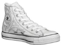 Denim Chuck Taylors  Inside patch view of a left white and grey denim high top with stitched details.