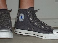 Distressed High Top Chucks  Wearing distressed black high top chucks, angled front view.
