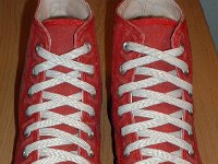 Distressed High Top Chucks  Distressed red high tops, top view.