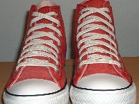 Distressed High Top Chucks  Front view of distressed red high tops.