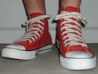 Distressed High Top Chucks  Wearing red distressed high top chucks, front view.
