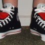 Double Tongue High Top Chucks  Wearing black and red double tongue high tops, front view.