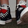 Double Tongue High Top Chucks  Stepping out in black and red double tongue high tops, front view.