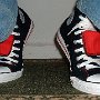 Double Tongue High Top Chucks  Stepping up in black and red double tongue high tops, front view.