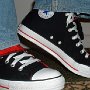 Double Tongue High Top Chucks  Stepping up in black and red double tongue high tops, angled front and side views.