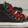 Double Upper High Top Chucks  Outside view of a right black, red, and white double upper high top, with the outer upper rolled down.