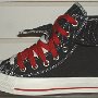 Double Upper High Top Chucks  Outside view of a left black, red, and white double upper high top, with the outer upper rolled down.