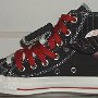 Double Upper High Top Chucks  Inside patch view of a right black, milk, and red double upper high top, with the outer upper rolled down.