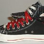 Double Upper High Top Chucks  Inside patch view of a right black, red, and milk double upper high top, with the outer upper rolled down.