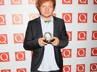 Ed Sheeran  Ed Sheeran posing with a music award.
