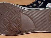 Evolution of the Outer Sole  Close up of the left outer sole from a pair of made in Viet Nam black high tops.