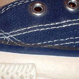 Evolution of the Outer Stitching  Close up of the left side outer stitching of a left 1970s navy blue high top.