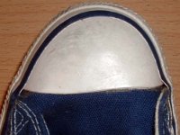 Evolution of the Toe Cap  Close up of the left toe cap on a pair of 1970s navy blue high tops.