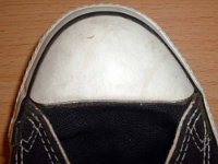Evolution of the Toe Cap  Close up of the right toe cap on a pair of early 1990s black high tops.