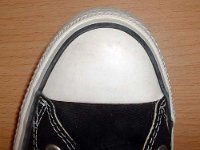 Evolution of the Toe Cap  Close up of the left toe cap from a pair of made in Viet Nam black high tops.