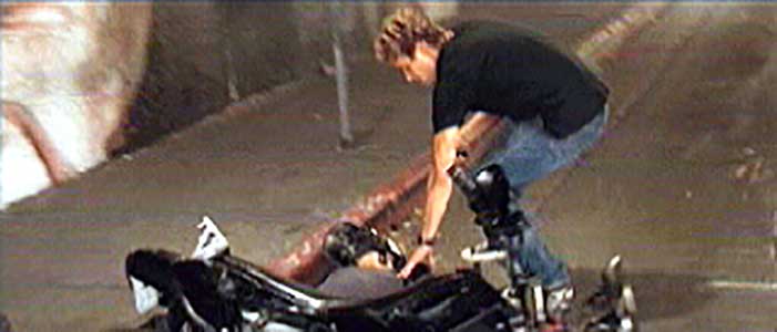 Brian checks to see if one of the motorcyle assassins from the Asian gang is dead
