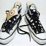 Flag Pattern Chucks  Black and white stars and bars high tops, angled front view.