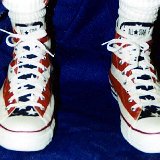 Flag Pattern Chucks  Wearing stars amd bars high tops, front view.