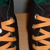 Foldover High Top Chucks  Black, green, amber foldover, showing close up of lace snap.