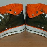 Foldover High Top Chucks  Angled front view of olive green and orange foldovers rolled down to the sixth eyelet.