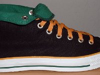 Foldover High Top Chucks Gallery 4  Outside view of a right black, green, and amber high top rolled down to the seventh eyelet.