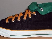 Foldover High Top Chucks Gallery 4  Outside patch view of a left black, green, and amber high top rolled down to the seventh eyelet.