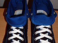 Foldover High Top Chucks Gallery 4  Angled front and top view of black and royal blue high tops rolled down to the seventh eyelet.
