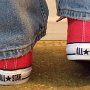 Foldover Double Upper High Top Chucks  Wearing folded down red foldover double upper high top chucks with blue jeans, rear view.
