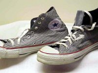 Chucks with Geometric Pattern Uppers  Gray and white fine checkered high tops, made with optical white piping and foxing. Angled side view.
