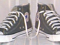 Grey Chucks  Charcoal high tops, angled front view.