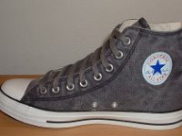 Grey Chucks  Inside patch view of a right distressed black high top.